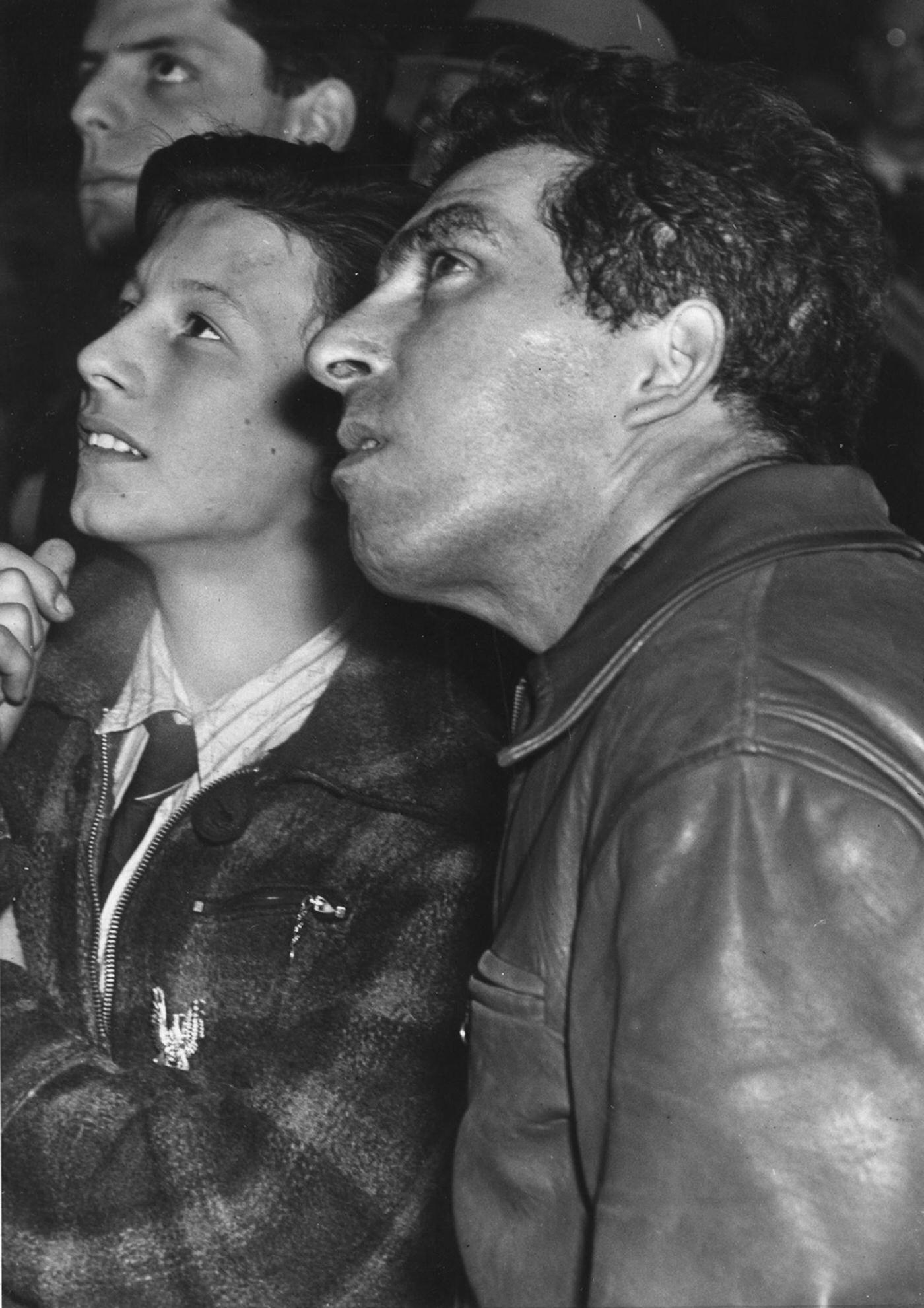 Two men looking up at the Empire State Building