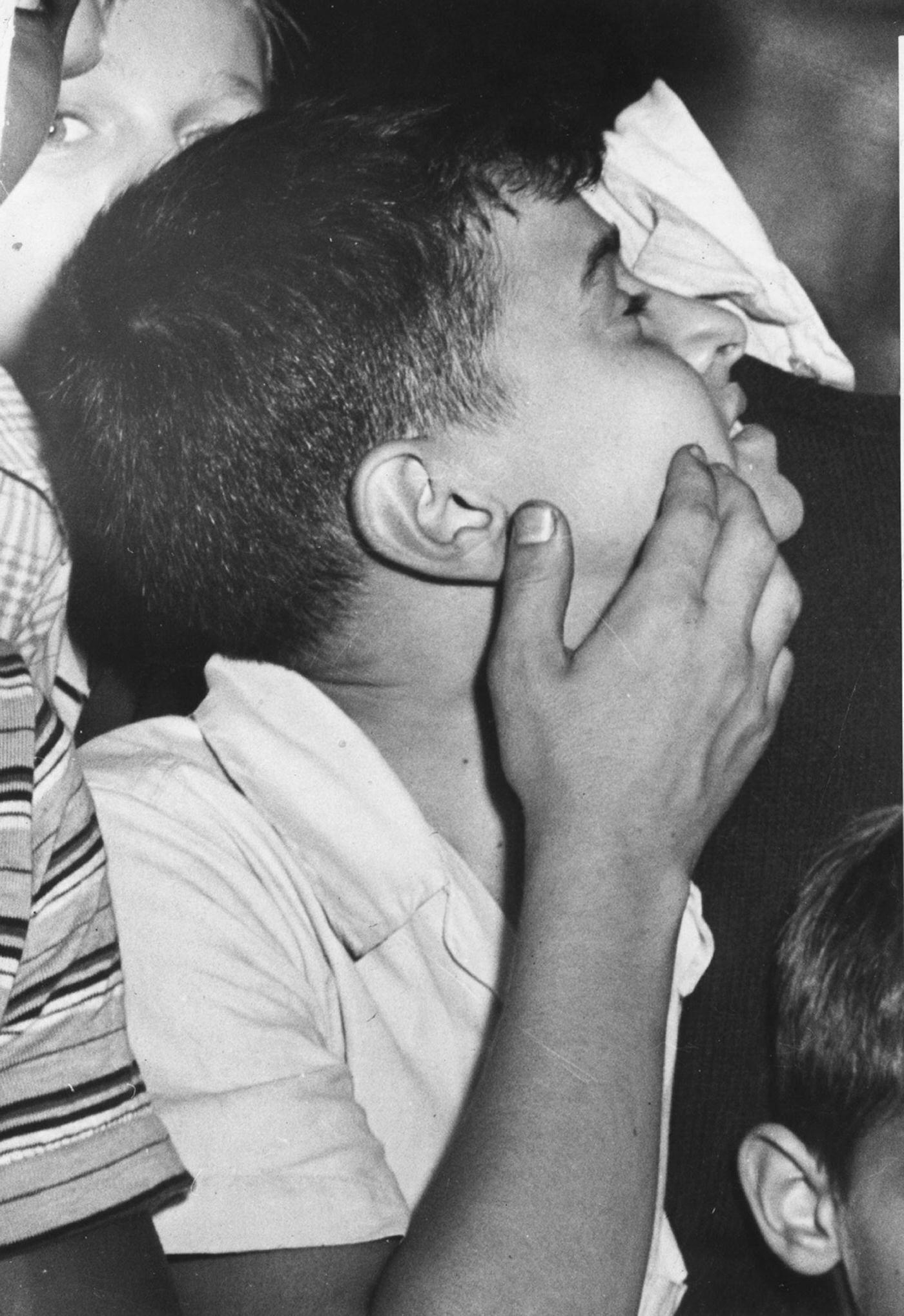 A boy looking up at the Empire State Building where a plane (a North American Aviation B-25 Mitchell bomber) had crashed into the building