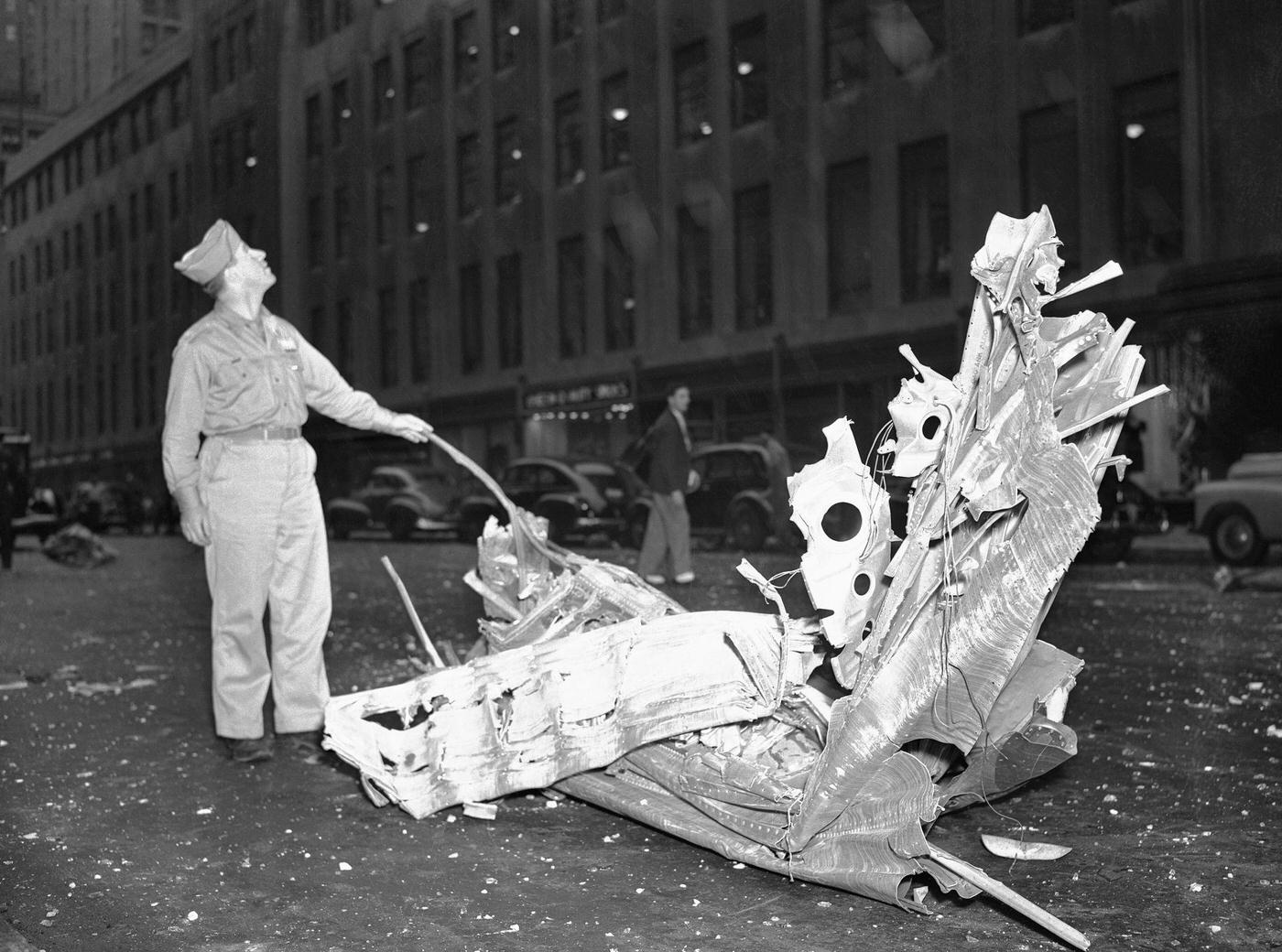 Man Looking at Plane Crash Debris