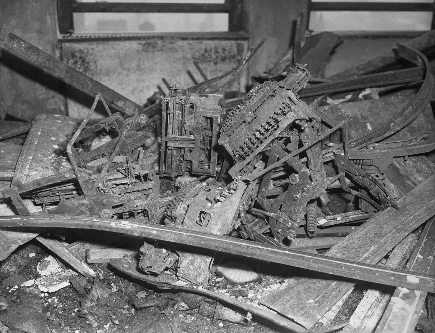 Twisted metal is all that remains of typewriters at National Catholic Welfare Conference, on 79th floor of Empire State Building. Restoration work is proceeding at rapid pace on two hardest hit floors.