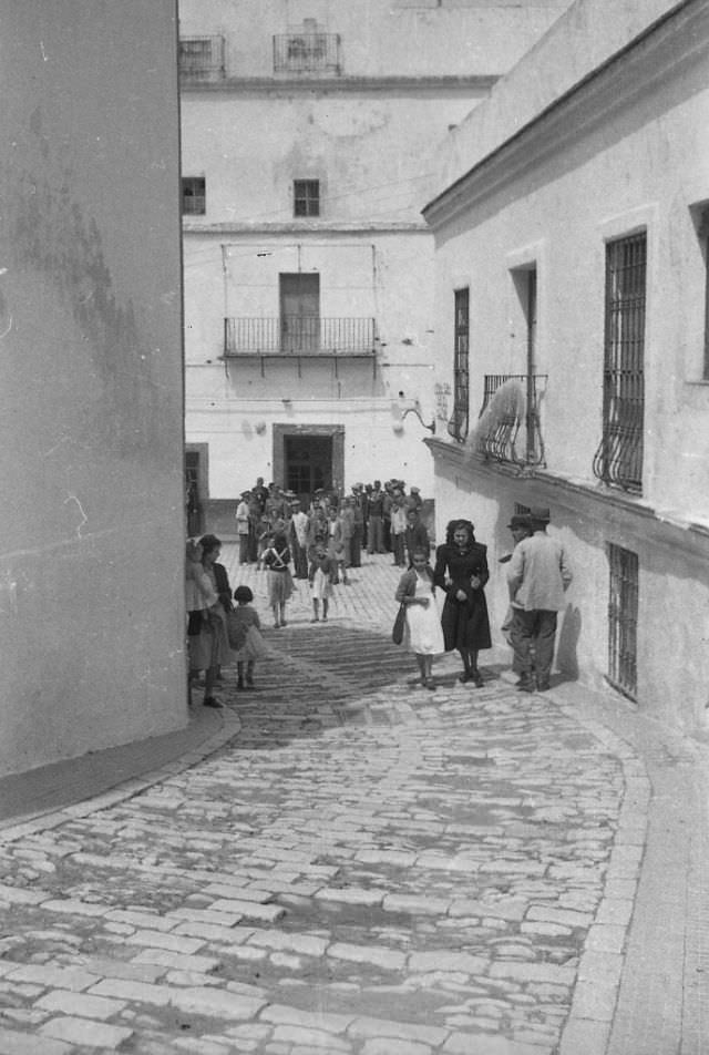 Spain. Alley with woman and child, 1950