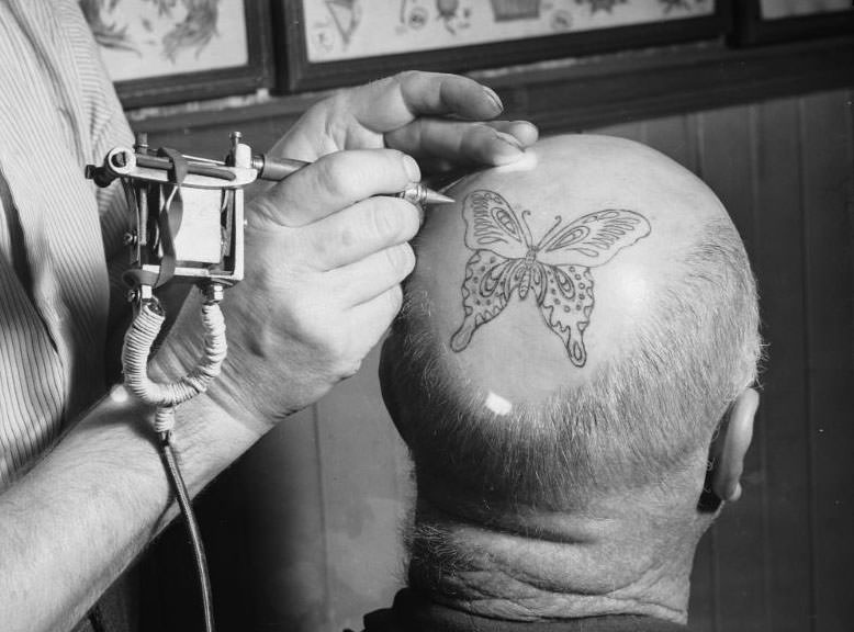 Tattooing a mans head with a butterfly, Fred Harris Tattoo Studio, Sydney, 17 December 1937