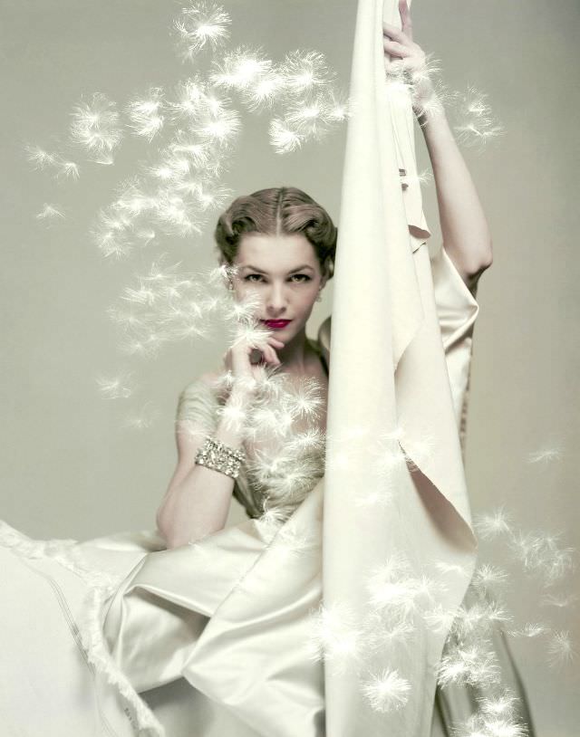Georgia Hamilton in silk taffeta dress holding yards of silk by Ducharne and C.M. Gourdon, Vogue 1949