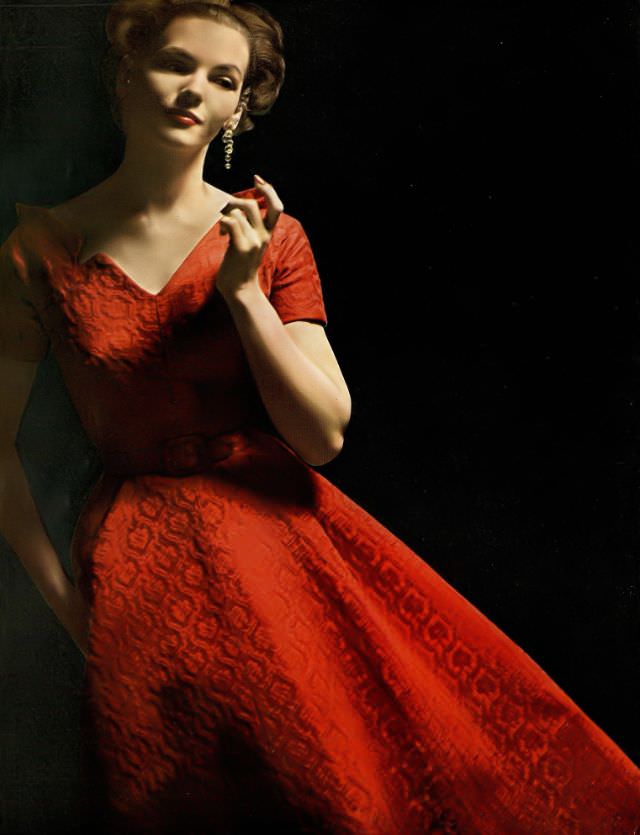 Georgia Hamilton in red damask evening dress by Richard Cole for Carolyn Modes, crystal drop earrings by Mosell, August 1953