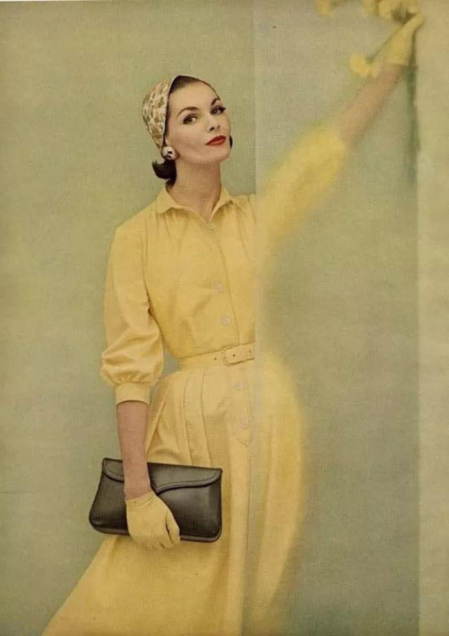 Georgia Hamilton wearing a yellow cotton shirtdress, 1955