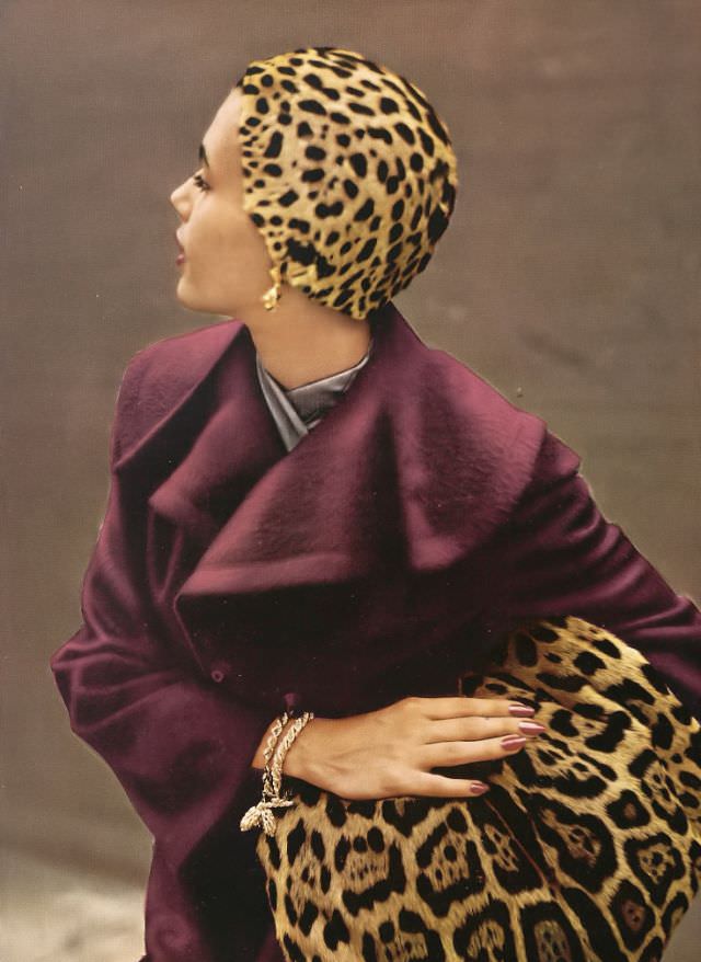 Georgia Hamilton poses in a plum-colored coat designed by Pauline Trigere, jaguar hat skull cap by Mr. John, jaguar muff by Aaron Reiss, jewelry by Schlumberger, 1949