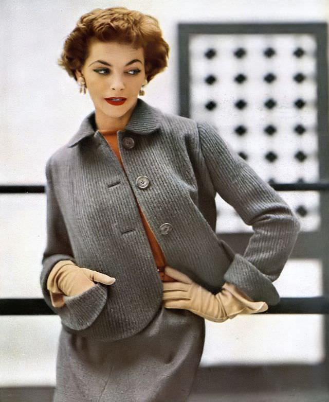 Georgia Hamilton in heavy ribbed wool jacket worn with gray flannel skirt, gold pine cone earrings by Black, Starr & Gorham, Ektachrome by Lillian Bassman, Harper's Bazaar, September 1951
