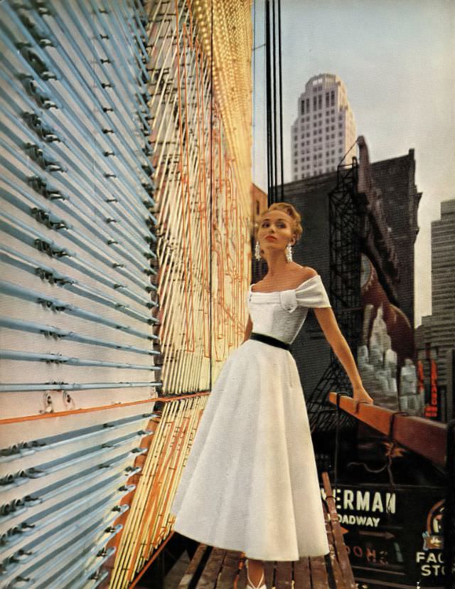 Sandra Nelson in white silk organdy dress with a little shawl around the shoulders by Mollie Parnis, photo by Gleb Derujinsky, Harper's Bazaar, December 1952