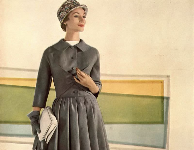 Ruth Neumann Derujinsky in gray flannel suit, jacket is folded envelope-style at the waist, skirt is lined with organdie to billow out by Marquise, cloche by Emme, photo by Gleb Derujinsky, Harper's Bazaar, February 1957
