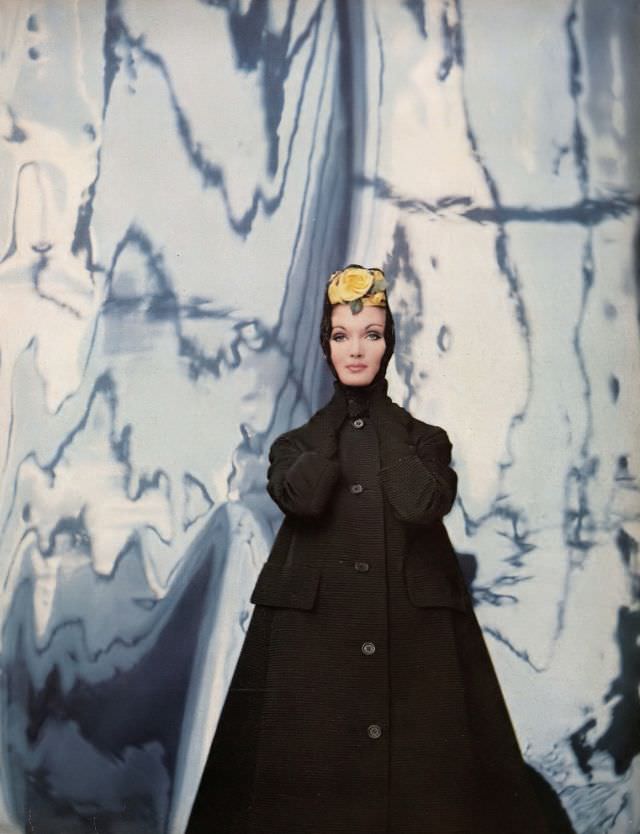 Evelyn Tripp in triangular black ottoman coat with a cardigan collar by Originala, mantilla with yellow rose by Emily Wetherby, photo by Gleb Derujinsky, Harper's Bazaar, February 1959