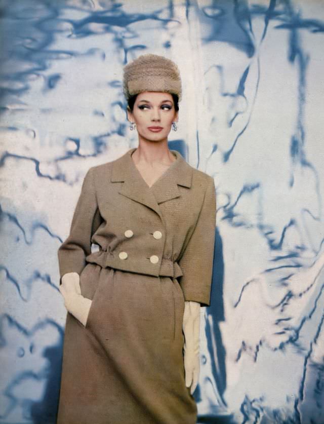 Simone d'Aillencourt in nut-beige wool jersey suit, the short jacket has elasticized waist above slender gathered skirt by Ben Zuckerman, hat by Lilly Daché, photo by Gleb Derujinsky, Harper's Bazaar, February 1959