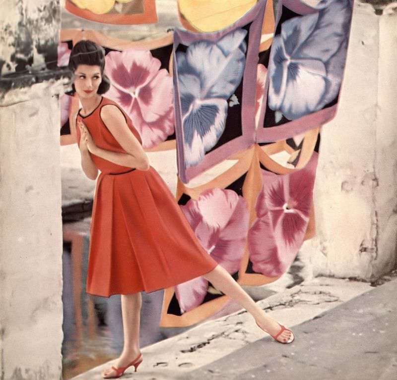 Simone d'Aillencourt in red linen top trimmed in black braid and skirt with inverted pleats by Sloat, red sandals by Mademoiselle, photo by Gleb Derujinsky, Harper's Bazaar, June 1959