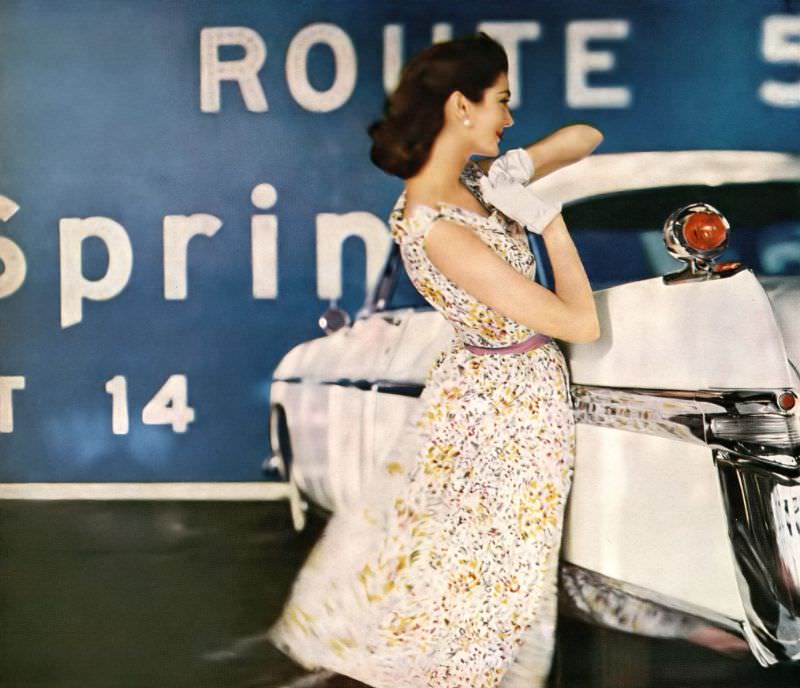 Carmen Dell'Orefice in summery shift of a dress dappled with wild flowers and sashed with a ribbon by David Crystal, photo by Gleb Derujinsky, the car is Chrysler's Imperial "Southampton", Harper's Bazaar U.S., May 1956