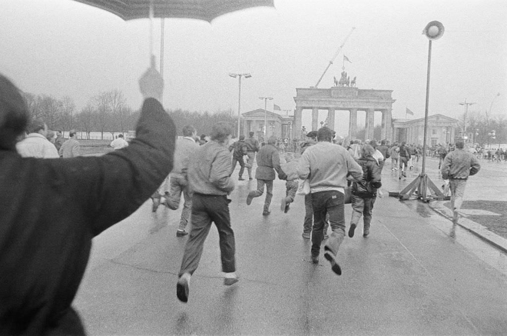 After the opening of the Wall on December 22nd, 1989, people walk towards the Brandenburg Gate, 1989
