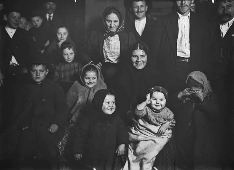 Joys and Sorrows at Ellis Island, 1905. A group of Slavic immigrants registers many shades of emotion. The baby salutes his new home — quite a family group.