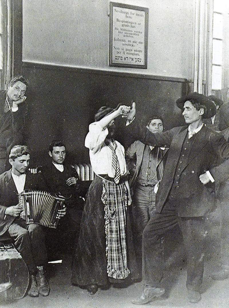 Immigrants detained at Ellis Island dancing.