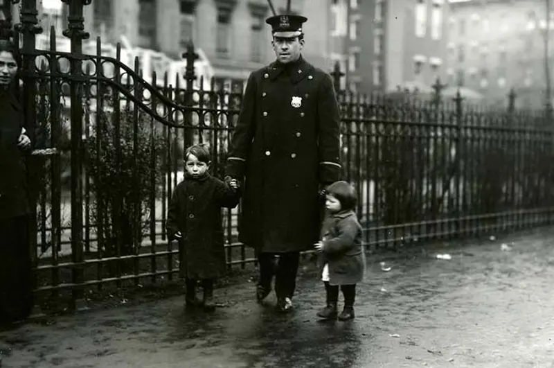 Cop brings them home alive, East Side, New York City, 1915.