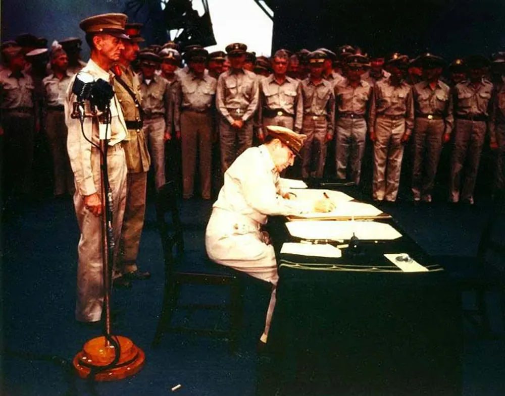 Gen. MacArthur signs Japanese Surrender Instrument.