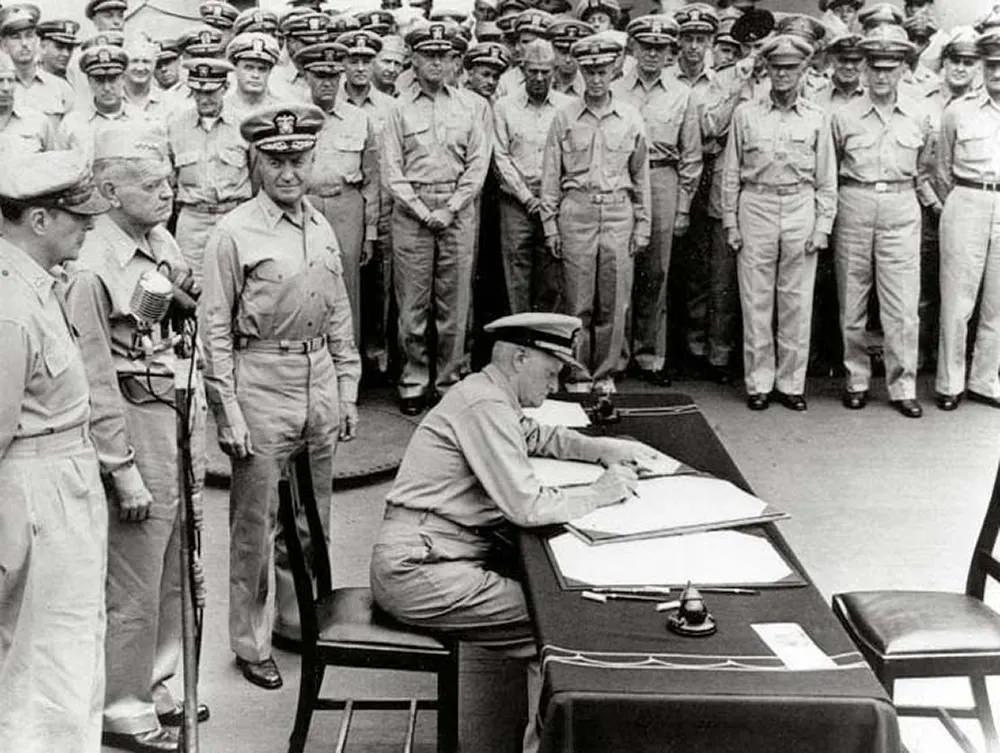 FAdm. Nimitz signs Japanese Surrender Instrument.