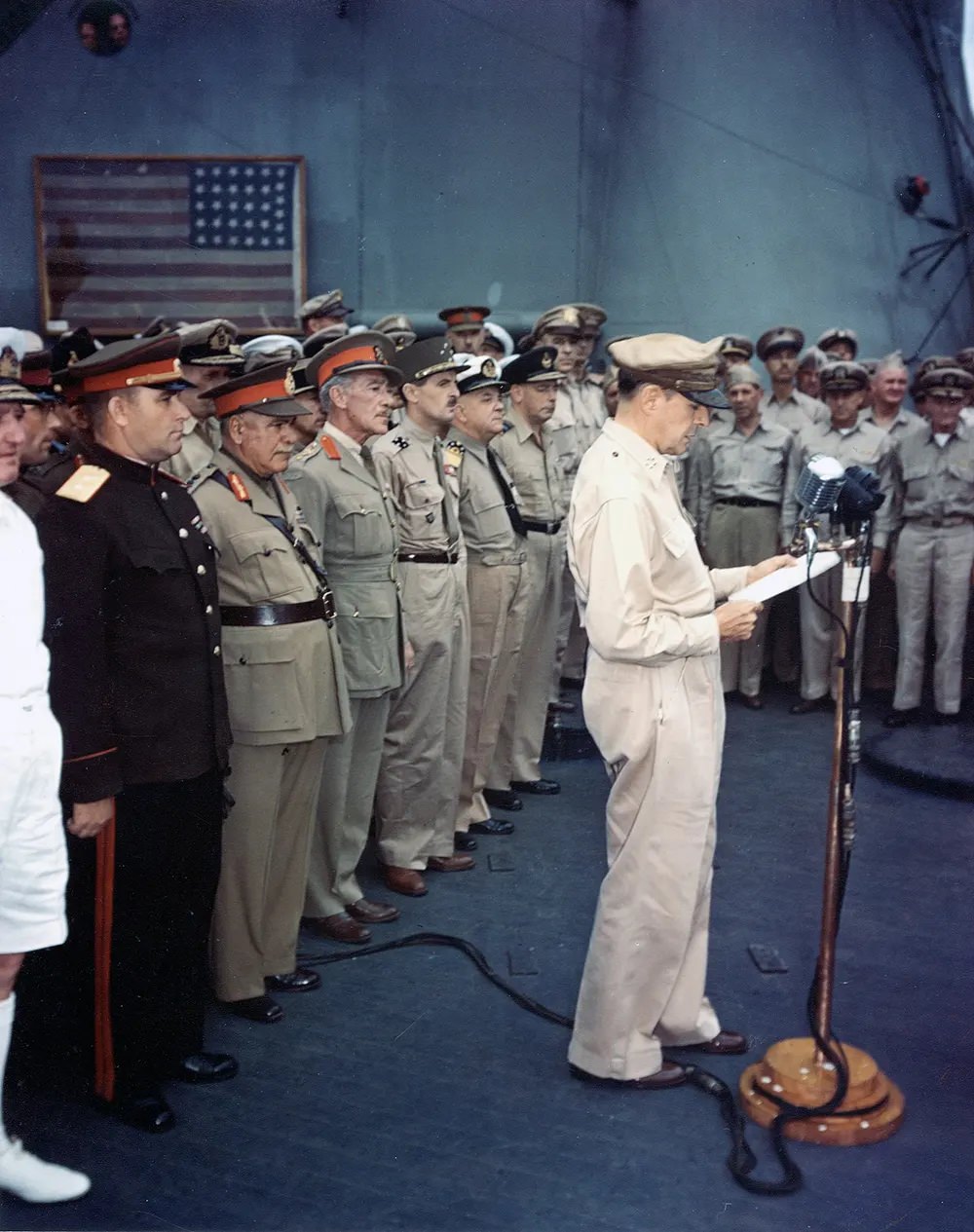 MacArthur at surrender ceremony. The flag flown by Perry is visible in the background.