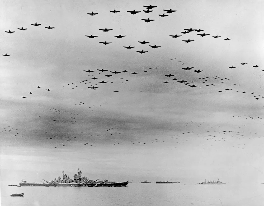Navy carrier planes fly in formation over the U.S. and British fleets in Tokyo Bay during surrender ceremonies.