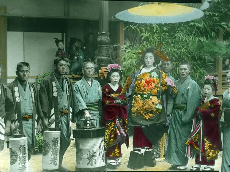 People in special attire, with lanterns, posing for photograph.