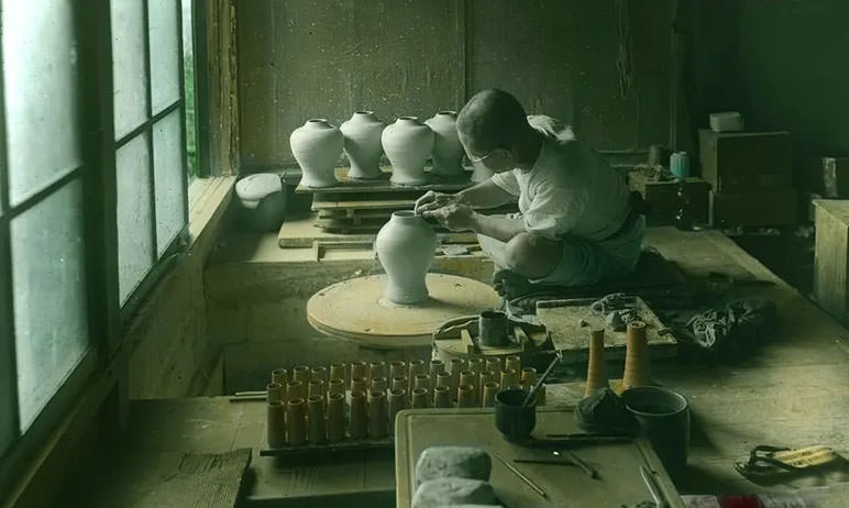 Potter making vase on wheel.