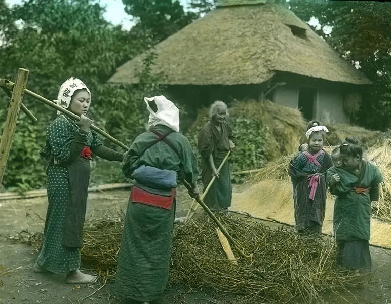 Women at work with children watching.