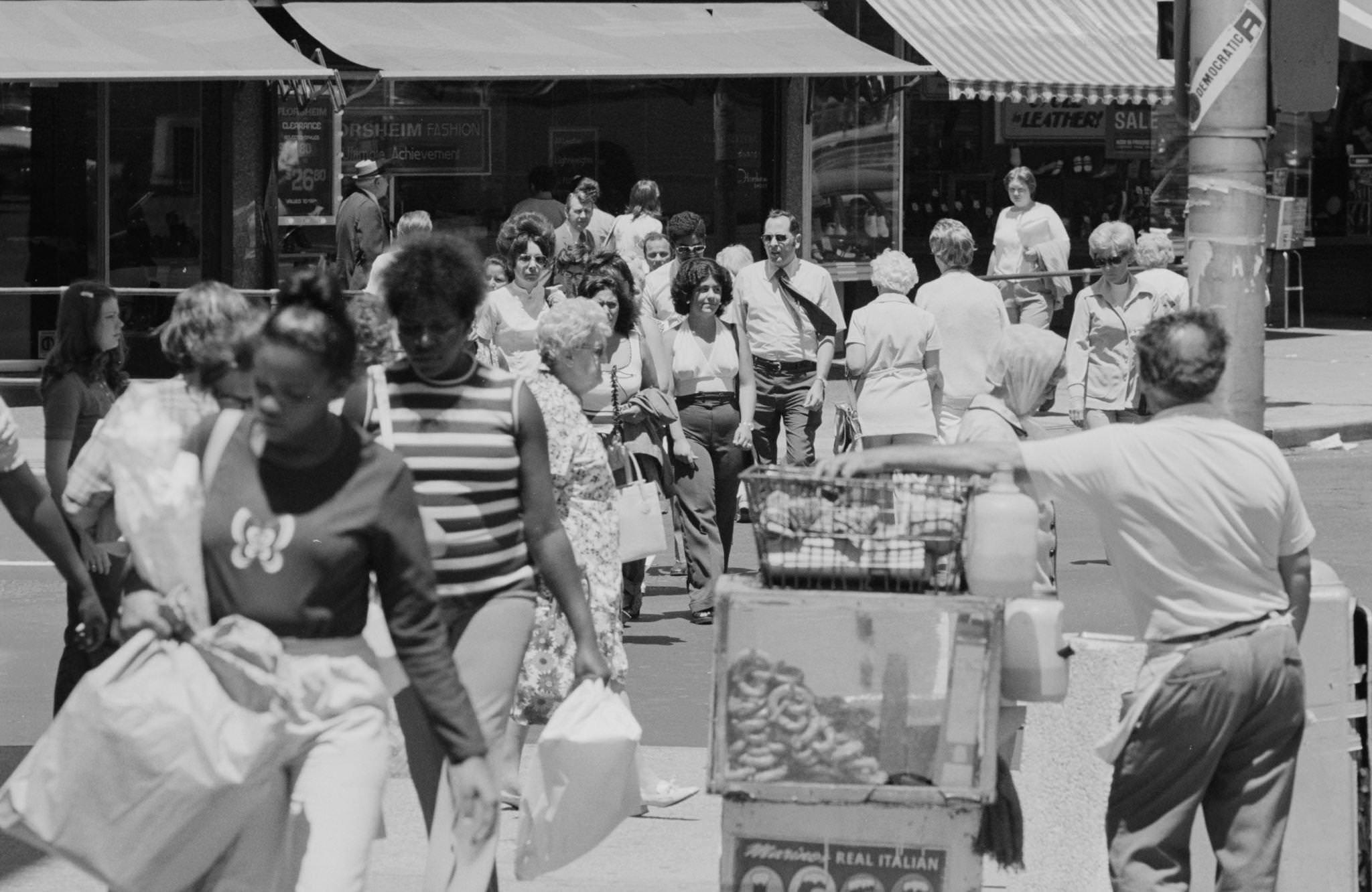 View of pedestrians crossing the street at an unidentified street corner of Jersey City, New Jersey, 1974.