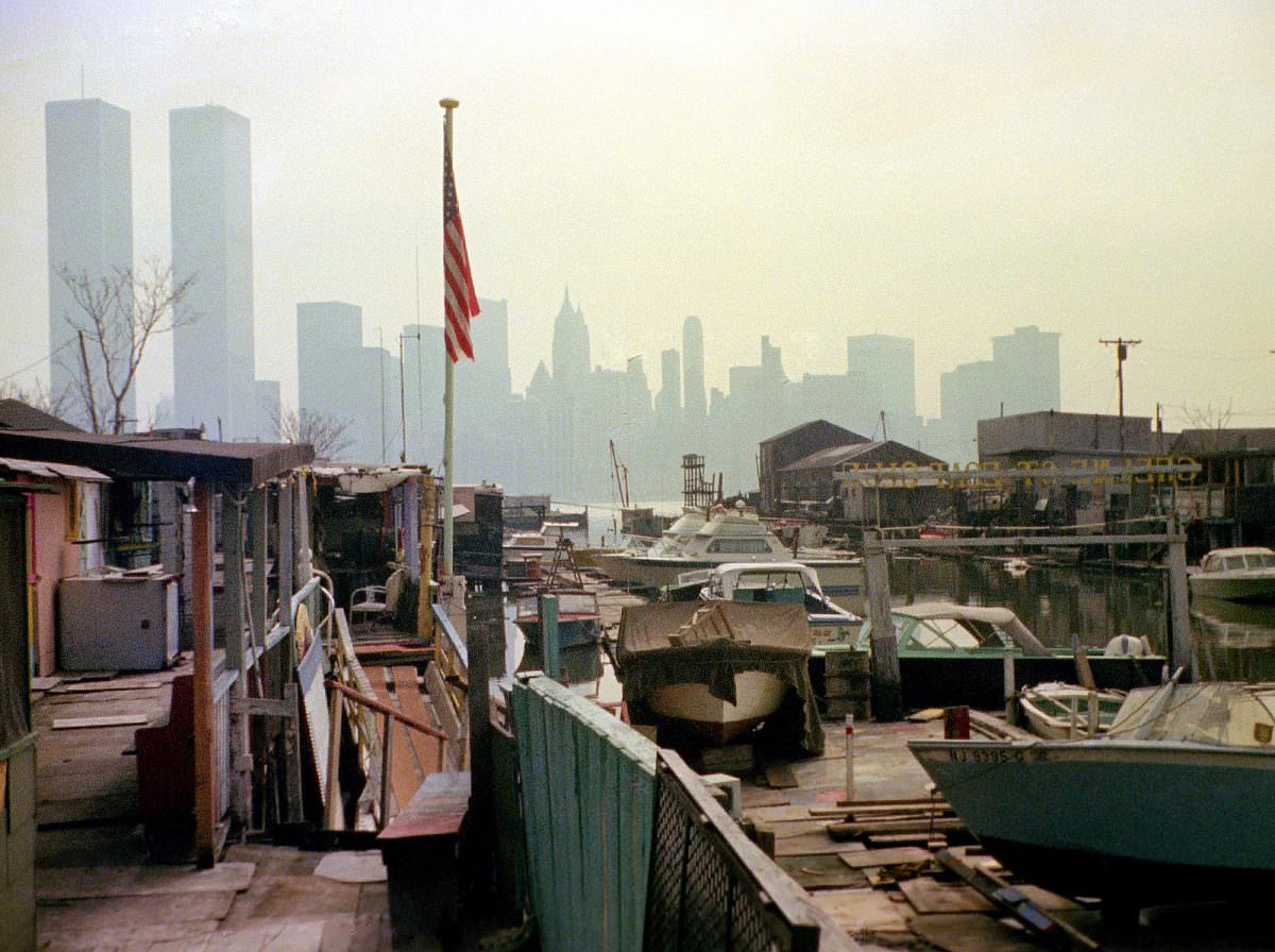 The ramshackle Greene Street Boat Club in Jersey City with the Lower Manhattan skyline and the World Trade Center in the distance, March 1975