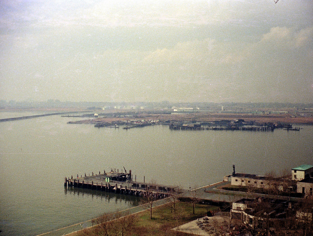 Industrial, railroad and rotting pier ruins in Jersey City from the Statue of Liberty, March 1973