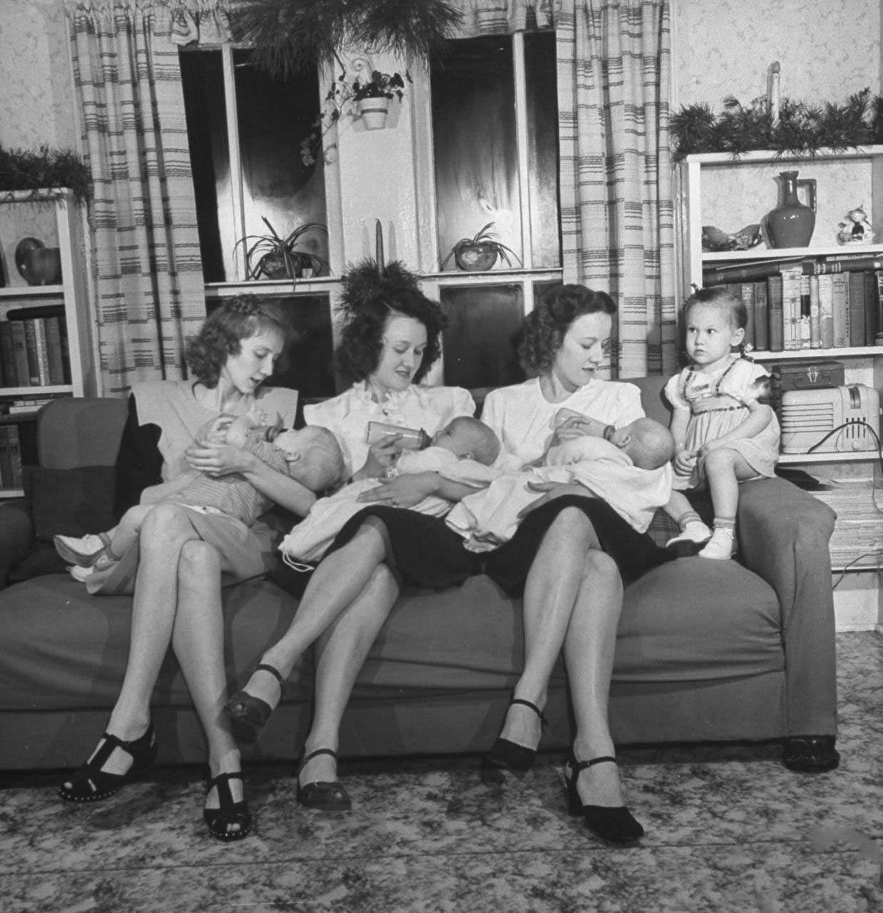 Daughters of James Ferdinand Irwin bottle-feeding their babies at Christmas family reunion celebration marking the return of Irwin's sons fr. service in WWII, L-R: Jeanne Haney & son Joe, Myra Lee Love & son John, Betty Roush and her daughters Julia Ann .
