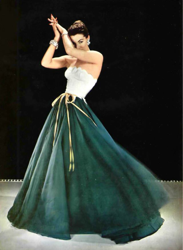 Lucky in evening gown, the skirt in two tones of silk organza, the bodice is scalloped on top and pointed below the waist, tied with gold ribbons, by Grès, 1954