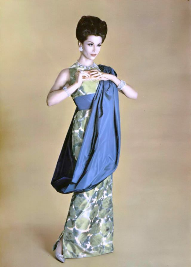 Jean Newington in blue and green print taffeta evening gown with blue taffeta circular stole, by Grès, jewelry by Van Cleef & Arpels, 1959