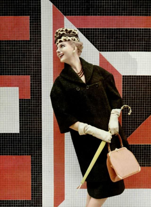 Model in silky wool coat by Grès, hat by Jean Barthet, handbag by Durer, necklace by Scémama, 1959