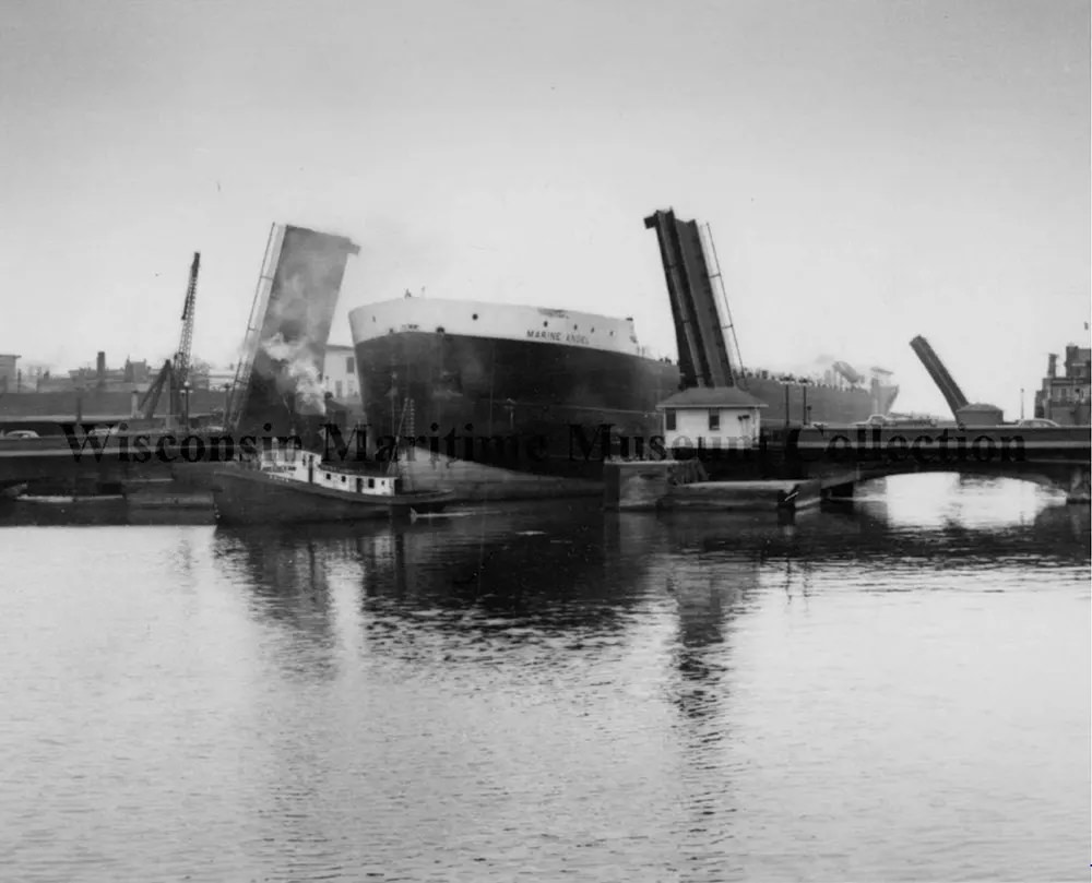Steamer Tug Reiss towing the Marine Angel through to Manitowoc Bridge, 1953.
