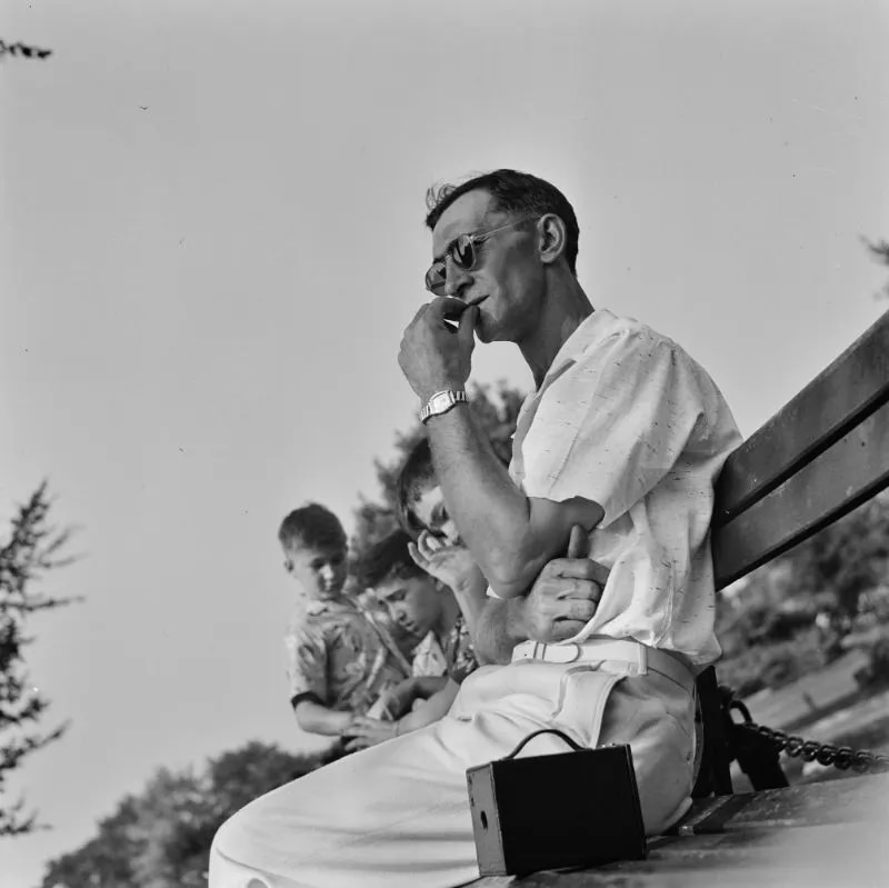 A Worker resting on a park bench in the zoological park, Detroit, Michigan, July 1942.