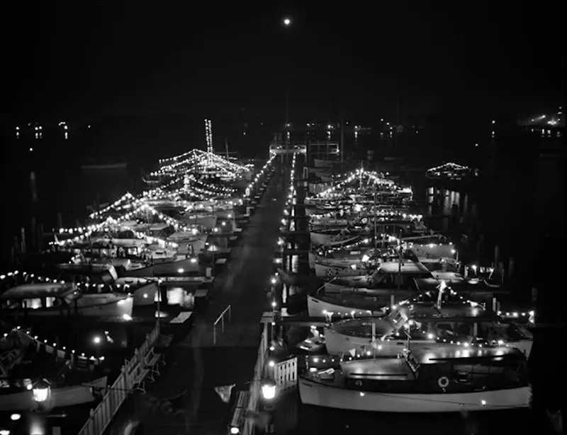 Cabin cruisers and sailboats decorated with lights, 1940