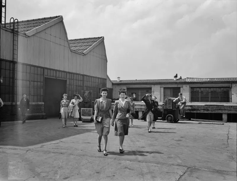 Girls coming out of the Highland Park Chrysler plant in Detroit, Michigan, 1942.