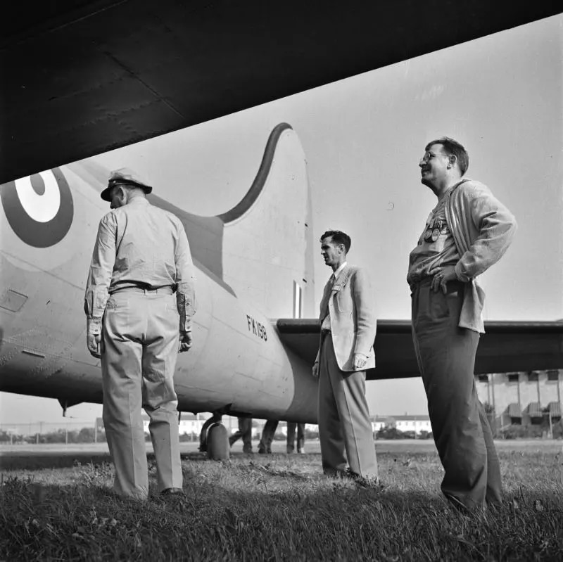Workers inspecting a plane at the Wayne County Airport, a United States Army Air Corps air ferry command base sixteen miles from Detroit, Michigan, September 1942.
