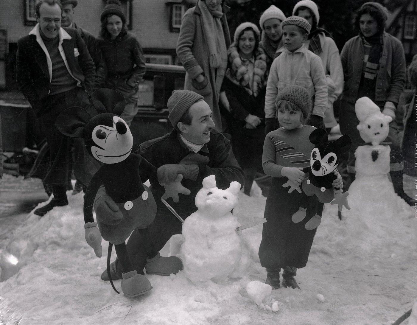 Walt Disney judging Mickey Mouse Snowman Building Contest