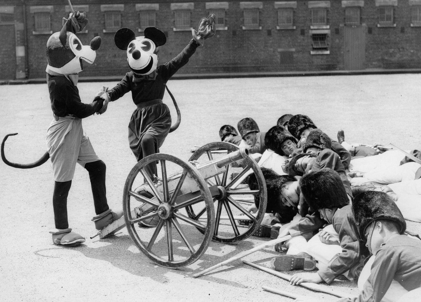 Mickey and Minnie Mouse and toy soldiers. A dress rehearsal of the Woolwich Searchlight Tattoo for the next month held tattoo, June 17th 1933.