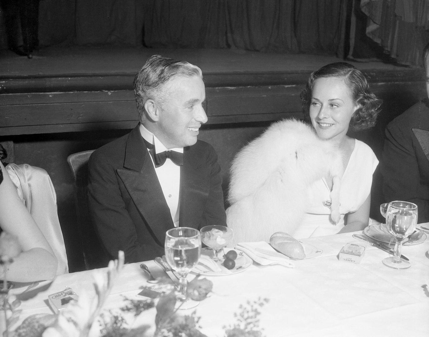 Charlie Chaplin and Paulette Goddard at party for Mickey Mouse