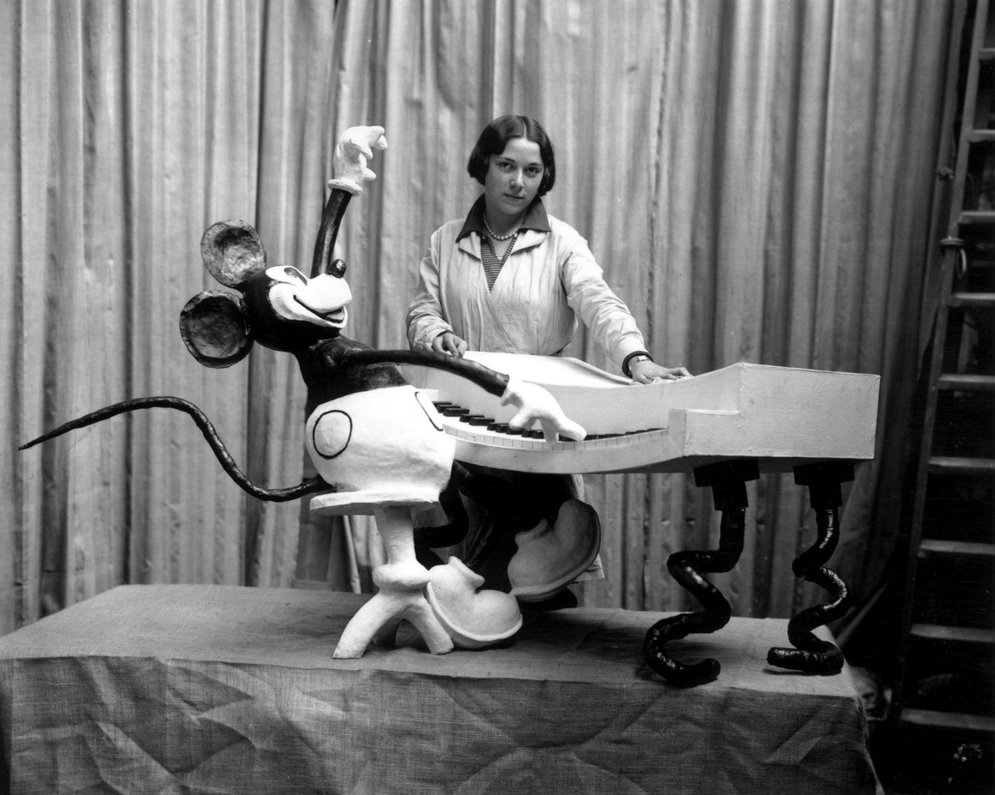 An employee at Madame Tussaud's waxworks museum on Marylebone Road, London, putting the finishing touches to a waxwork of Mickey Mouse at the keyboard