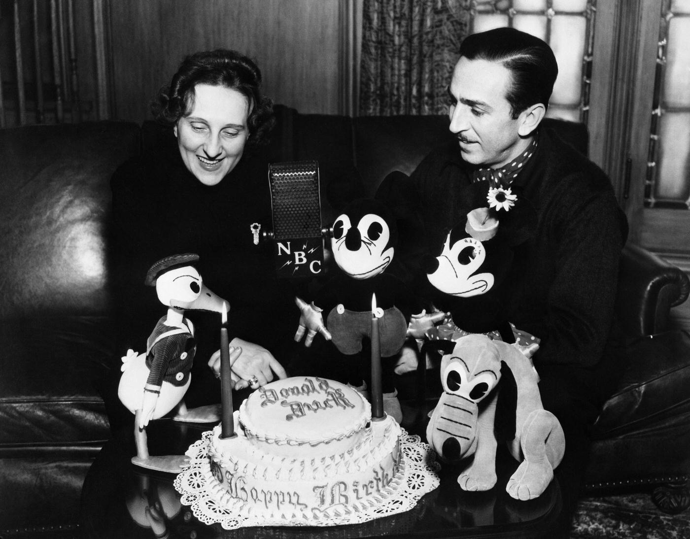 Walt Disney. Donald Duck, Elza Schallert, Mickey Mouse, Walt Disney, Minnie Mouse, Pluto with a birthday cake for Donald