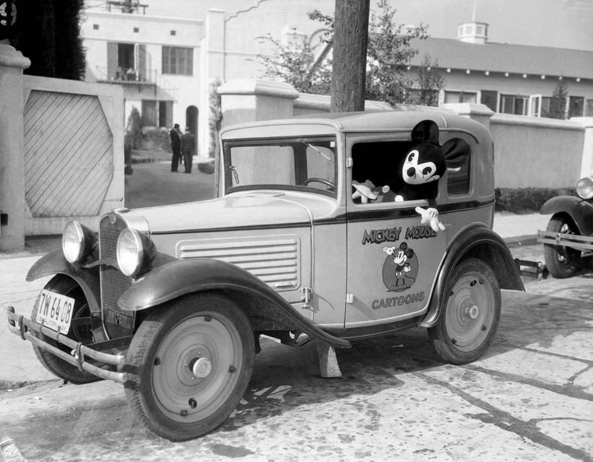 Mickey Mouse at the wheel of a car bearing his personal coat of arms, at the Mickey Mouse Studios just outside of Los Angeles on Feb. 21, 1933.