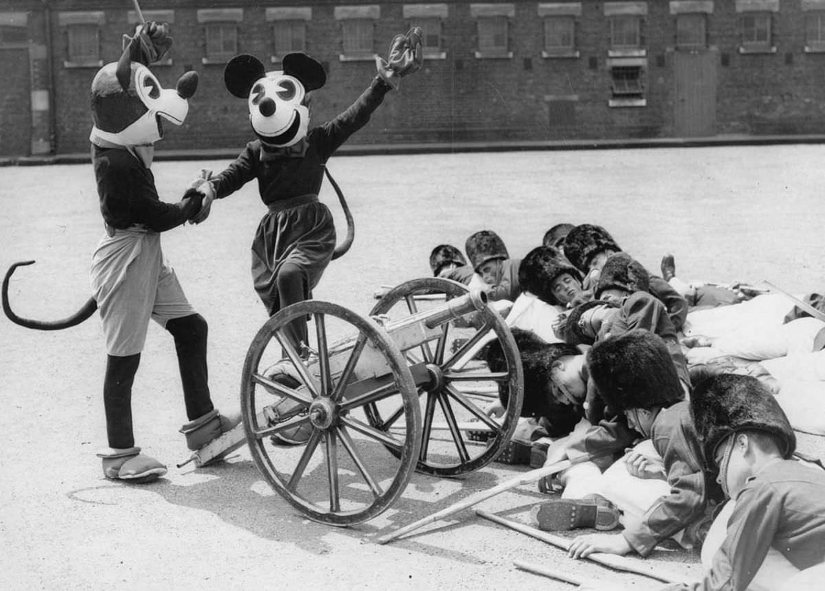 Mickey and Minnie Mouse at a dress rehearsal of the Woolwich Searchlight Tattoo, London, 1933.