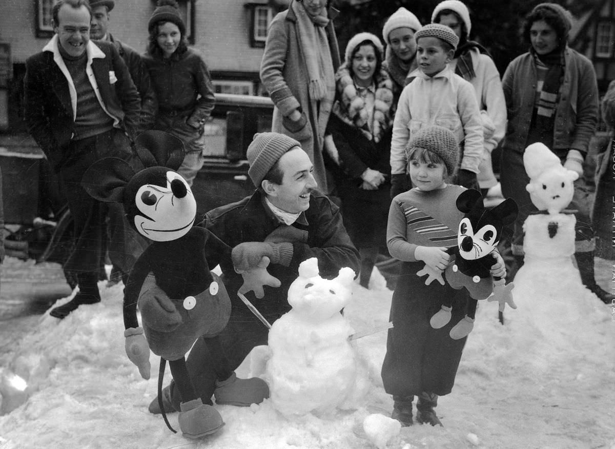 Walt Disney congratulates Mildred Lee Chanter for winning a contest for making the best Mickey out of snow in Lake Arrowhead, California, 1933.