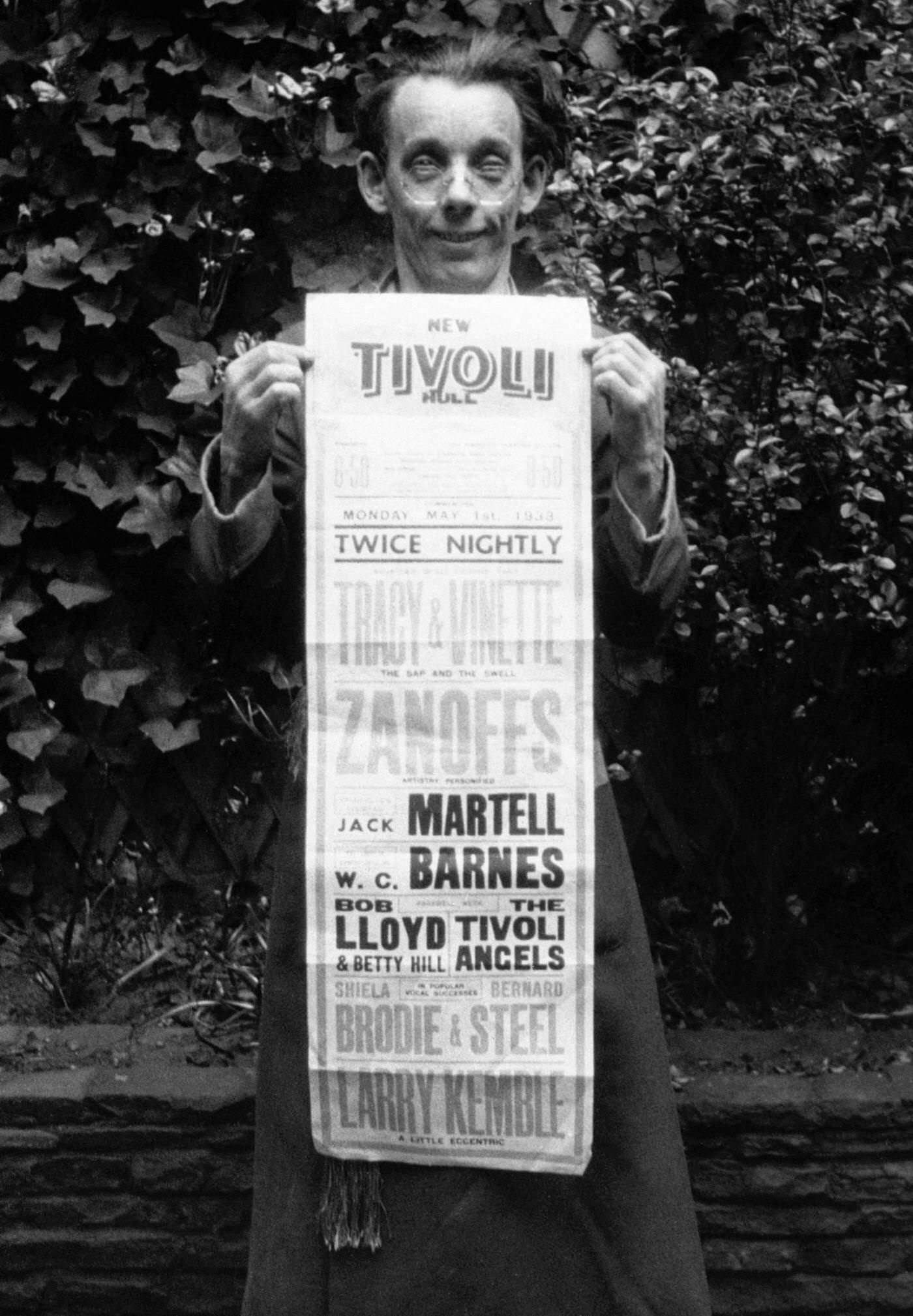 Dancer Jack Tracy holds up an advertisement. Tracy was the human model for the Mickey Mouse films and is now dancing with his partner Miss Vinette.