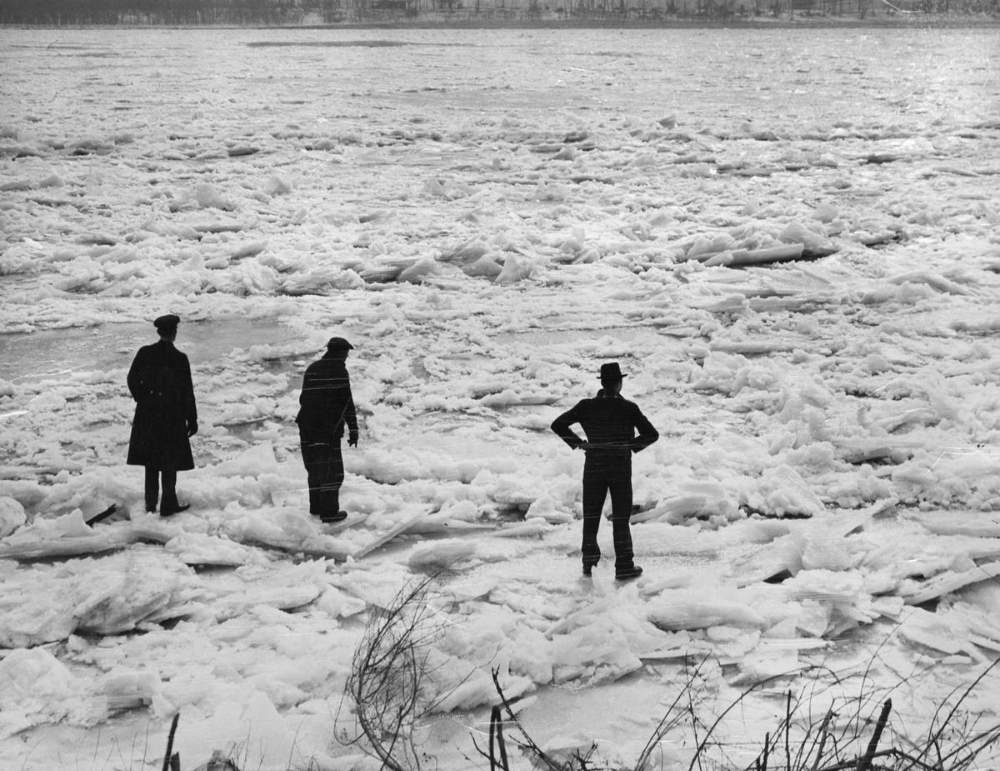 Three men prepare to walk across the river from the foot of Gasconade Street in south St. Louis on Feb. 7, 1936, after a massive ice jam covered the river.
